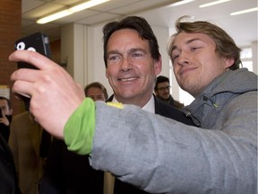 Laval University student Alexandre Thibault, right, takes a selfie with Parti Quebecois leadership candidate Pierre Karl Péladeau following a speech to students, Wednesday, February 11, 2015 at Laval University in Quebec City.