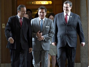 From left: Quebec Labour Minister Sam Hamad, Municipal Affairs Minister Pierre Moreau, flanked by Quebec Labour Minister Sam Hamad, left, and Quebec Employment and Social Solidarity Minister Francois Blais in June 2014.