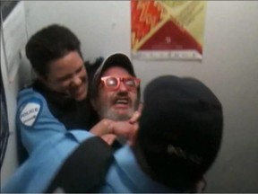 Police constable Stéfanie Trudeau holds a man with glasses in a chokehold in an October 2, 2012 profanity-laced arrest recorded on video.