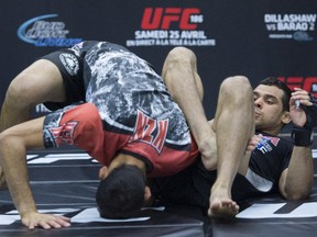 UFC bantamweight challenger Renan Barao from Brazil, right, runs through some training moves during a UFC 186 media event in Montreal, on Feb. 25, 2015.