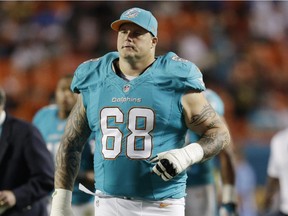Dolphins guard Richie Incognito walks across the field for the second half of NFL game against the Cincinnati Bengals in Miami on Oct. 31, 2013 .