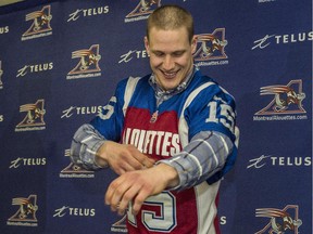 Samuel Giguère tries on his new uniform at a press conference on Friday, February 13, 2015.