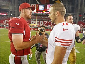 Quarterbacks John Skelton (#19) of the Arizona Cardinals and Alex Smith (#11) of the San Francisco 49ers greet each other at midfield at the end of an NFL game at University of Phoenix Stadium on October 29, 2012 in Glendale, Arizona.