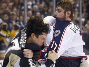The Pittsburgh Penguins' Sidney Crosby (left) and the Columbus Blue Jackets' Brandon Dubinsky exchange blows during a fight on Feb. 19, 2015 in Pittsburgh.