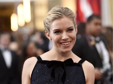 Sienna Miller arrives at the Oscars on Sunday, Feb. 22, 2015, at the Dolby Theatre in Los Angeles.