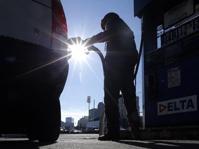 Sonu Singh, an employee at a Delta gas station in downtown Newark, N.J., pumps gas for a motorist Jan. 23, 2015.