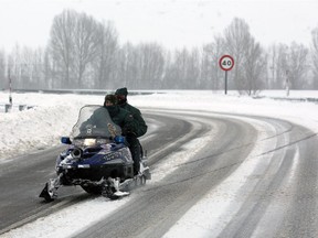 Guardia Civil ride a snowmobile on the snow-covered A-64 highway near Aguilar de Campoo during heavy snowfall on February 5, 2015.