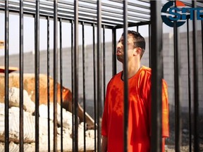This still image made from video released by Islamic State group militants and posted on the website of the SITE Intelligence Group on Tuesday, Feb. 3, 2015, purportedly shows Jordanian pilot Lt. Muath al-Kaseasbeh standing in a cage just before being burned to death by his captors.