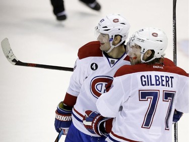 Montreal Canadiens left wing Max Pacioretty, left, and defenceman Tom Gilbert (77) celebrate teammate Tomas Plekanec's goal during the third period of an NHL hockey game against the Detroit Red Wings, Monday, Feb. 16, 2015, in Detroit. Montreal won 2-0.