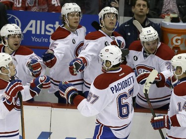 Montreal Canadiens congratulate centre Tomas Plekanec (14), of the Czech Republic, after his goal during the third period of an NHL hockey game against the Detroit Red Wings, Monday, Feb. 16, 2015, in Detroit. Montreal won 2-0.