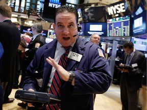 Trader Tommy Kalikas talks on his mobile phone as he works on the floor of the New York Stock Exchange Monday, Feb. 23, 2015. U.S. stocks are opening slightly lower, pulling the market back from an all-time high reached last week.