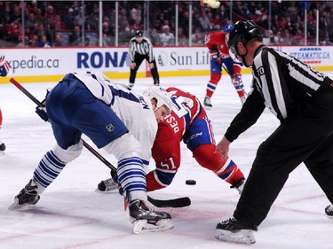 Olli Jokinen #11of the Toronto Maple Leafs and David Desharnais #51 of the Montreal Canadiens face-off during during an NHL game at the Bell Centre on Feb. 28, 2015 in Montreal, Quebec, Canada.