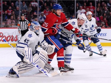 Jacob De La Rose #25 of the Montreal Canadiens battles for position in front of Jonathan Bernier #45 of the Toronto Maple Leafs during during an NHL game at the Bell Centre on Feb. 28, 2015 in Montreal, Quebec, Canada.