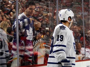 A fan offers Joffrey Lupul of the Toronto Maple Leafs a beer during game against the New Jersey Devils at the Prudential Center in Newark, N.J., on Feb. 6, 2015. The Devils beat the Leafs 4-1.