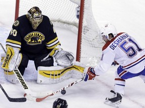 Boston Bruins goalie Tuukka Rask deflects a shot on goal by Montreal Canadiens centrer David Desharnais during the second period of an NHL hockey game, Sunday, Feb. 8, 2015, in Boston.