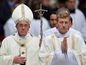 Pope Francis (L) leaves at the end of a mass at St Peter's basilica to celebrate the World Day for Consecrated Life on February 2, 2015 at the Vatican.