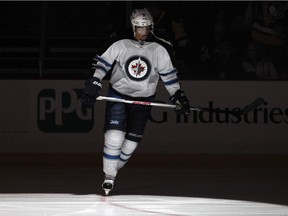 Evander Kane of the Winnipeg Jets skates on ice during player introductions before game against the Penguins at Pittsburgh's Consol Energy Center on Jan. 27, 2015.