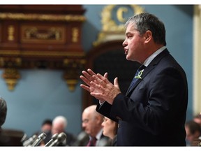 Quebec Education Minister Yves Bolduc responds to Opposition questions Tuesday, Feb. 17, 2015 at the legislature in Quebec City. Bolduc defended a school decision to strip search a 15-year-old girl.