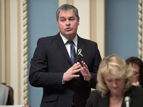 Quebec Education Minister Yves Bolduc responds to the Opposition over the strip search of a teenager woman, during question period Wednesday, February 18, 2015 at the legislature in Quebec City.