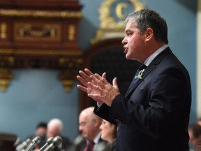 Quebec Education Minister Yves Bolduc responds to Opposition questions Tuesday, Feb. 17, 2015 at the legislature in Quebec City. Bolduc defended a school decision to strip search a 15-year-old girl.