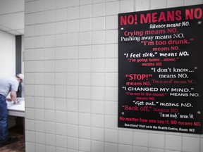 An anti-rape "no means no" sign in a men's washroom at Loyalist College in Belleville, Ont., on March 12, 2015.