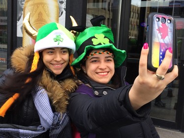 Geraldin Carpio, left, and Anghelina Rindone take a self-portrait as they wait for the start of the annual St. Patrick's parade in Montreal, Sunday, March 22, 2015.