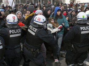 Police disperse demonstrators as students protest against proposed austerity changes by the provincial government on Monday, March 23, 2015 in Montreal. They were back in the streets again Tuesday night.