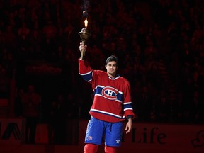 Canadiens' Max Pacioretty with the team's ceremonial torch before the team's first game of the 2014-15 season at the Bell Centre on Oct. 14, 2014.