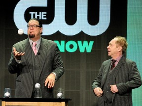 Magicians Penn Jillette (L) and Teller perform onstage at the "Fool Us" panel during the El Rey Network portion of the 2014 Summer Television Critics Association at The Beverly Hilton Hotel on July 18, 2014 in Beverly Hills, California.