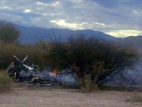 Picture of the burning wreckages of two helicopters which collided mid-air near Villa Castelli, in the Argentine province of La Rioja, on March 9, 2015. Eight French nationals, including sports stars, filming a reality TV show were killed Monday along with two Argentine pilots.