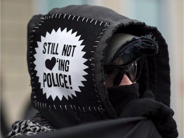 A demonstrator participates in the annual anti-police brutality demo, Sunday, March 15, 2015, in Montreal.