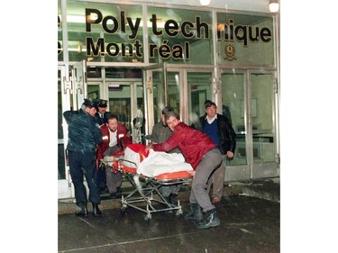 A victim is wheeled away from the Ecole Polytechnique after gunman Marc Lepine opened fire at the school in Montreal on Dec. 6, 1989. Twenty-five years ago, Marc Lepine went on a 20-minute shooting rampage that eventually sparked a national gun-control debate that continues until this day.