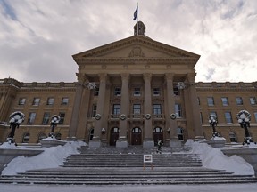 A worker puts down grit on the just shovelled front staircase of the Provincial Legislature in Edmonton on Friday Nov 28, 2014.