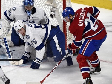 Center Alex Galchenyuk takes a shot as Tampa Bay Lightning goalie Ben Bishop and defenseman Braydon Coburn defend during second-period action at the Bell Centre on Tuesday, March 10, 2015.