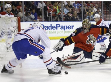 Montreal Canadiens centre Alex Galchenyuk attempts a shot as Florida Panthers goalie Dan Ellis defends during the first period Tuesday, March 17, 2015,  in Sunrise, Fla.