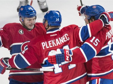 Montreal Canadiens' Tomas Plekanec celebrates with teammates Alex Galchenyuk, left and Pierre-Alexandre Parenteau, right, after scoring on the San Jose Sharks during first period NHL hockey action in Montreal, Saturday, March 21, 2015.