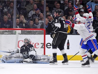 Montreal Canadiens' Alex Galchenyuk, right, and Tomas Plekanec, second from right, of the Czech Republic, celebrate a goal by Brendan Gallagher against Los Angeles Kings goalie Jonathan Quick during the second period of an NHL hockey game, Thursday, March 5, 2015, in Los Angeles. Kings' Matt Geene sakes next to Quick.