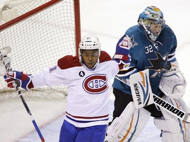 San Jose Sharks goalie Alex Stalock, right, stops a shot next to Montreal Canadiens' Devante Smith-Pelly (21) during the first period of an NHL hockey game Monday, March 2, 2015, in San Jose, Calif.