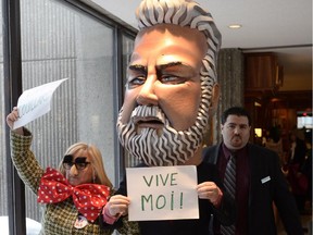 Anti-austerity protesters are removed before a speech by Quebec Finance Minister Carlos Leitão at the Chamber of Commerce in Montreal, Monday, March 30, 2015.