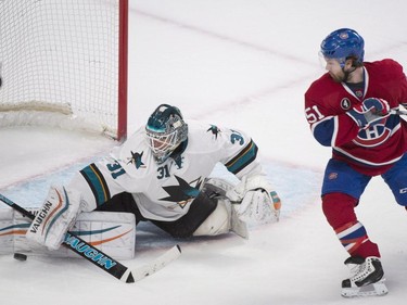 San Jose Sharks goaltender Antti Niemi makes a save on Montreal Canadiens' David Desharnais during first period NHL hockey action in Montreal, Saturday, March 21, 2015.