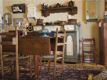 Assorted antique furniture pieces and objects fill the antique shop on the ground floor.