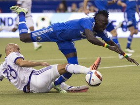 Montreal Impact's Dominic Oduro falls after being tackled by Orlando City SC's Aurelien Collin during second half MLS action on Saturday, March 28, 2015 in Montreal.