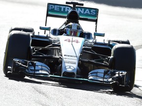 Mercedes driver Lewis Hamilton powers through a corner during practice session for the Formula One Australian Grand Prix in Melbourne on March 13, 2015.