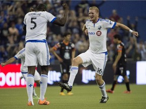 Montreal Impact Bakary Soumare, left, and Calum Mallace celebrate their 1-1 tie against Pachuca FC in CONCACAF soccer action Tuesday, March 3, 2015 in Montreal. The teams tied the two-game aggregate goals series 3-3, but Montreal won on the away goals rule after drawing 2-2 at Pachuca in the first leg last week.
