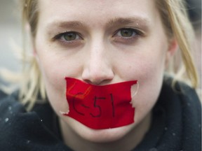 A woman protests on a national day of action against Bill C-51, the government's proposed anti-terrorism legislation, in Montreal, Saturday, March 14, 2015.