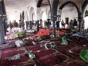 Bodies of people killed in a suicide attack during the noon prayer are covered in blankets in a mosque in Sanaa, Yemen, Friday, March 20, 2015. Four  suicide bombers hit a pair of mosques crowded with worshippers in the Yemeni capital, Sanaa, on Friday, causing heavy casualties, according to witnesses.