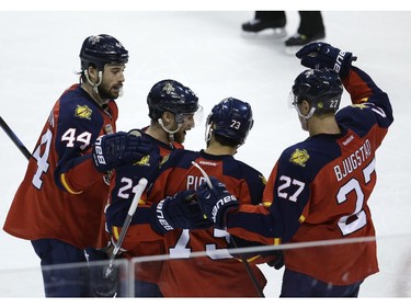 Florida Panthers centre Brandon Pirri (73) celebrates with Erik Gudbranson (44), Brad Boyes (24) and Nick Bjugstad (27) after scoring a goal against the Montreal Canadiens on Tuesday, March 17, 2015,  in Sunrise, Fla.