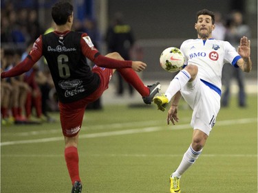 Montreal Impact's Calum Mallace, right, goes after a loose ball with LD Alajuelense's Jose Salvatierra during first half CONCACAF semi-final soccer action Wednesday, March 18, 2015, in Montreal.