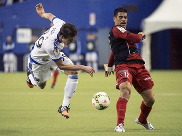 Montreal Impact's Cameron Porter and LD Alajuelense's Jhonny Acosta battle for the ball during second half CONCACAF soccer semi-final action Wednesday, March 18, 2015, in Montreal.