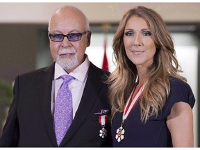 Céline Dion and husband René Angélil pose for photos after being decorated with the Order of Canada in Quebec City on July 26, 2013.